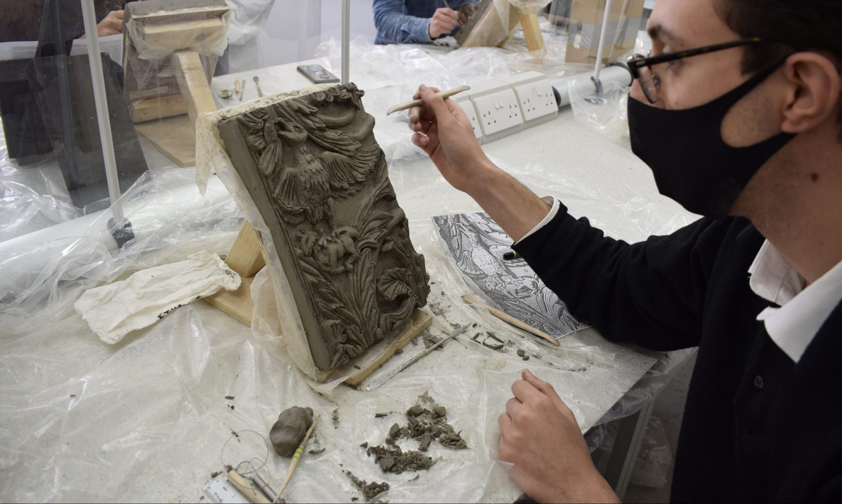 How can an Art School function during a global pandemic? - BA Conservation student in bas relief workshop