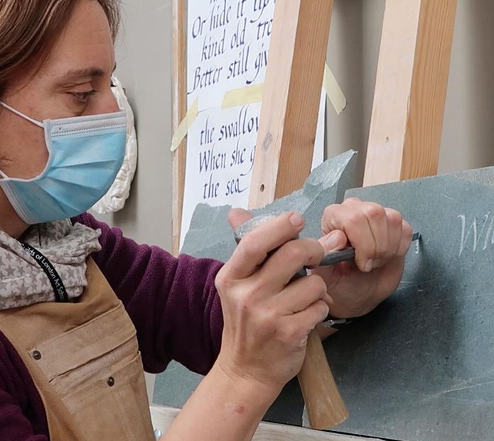 How can an Art School function during a global pandemic? - Stone Carving student carving lettering onto slate